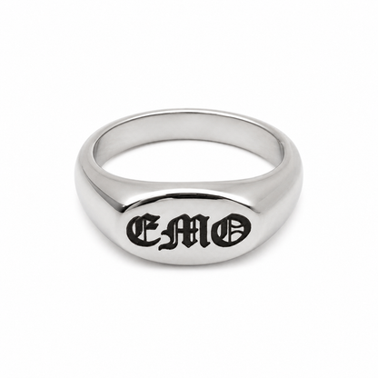 A polished silver signet ring engraved with the gothic-style letters 'EMO' on a clean white background.