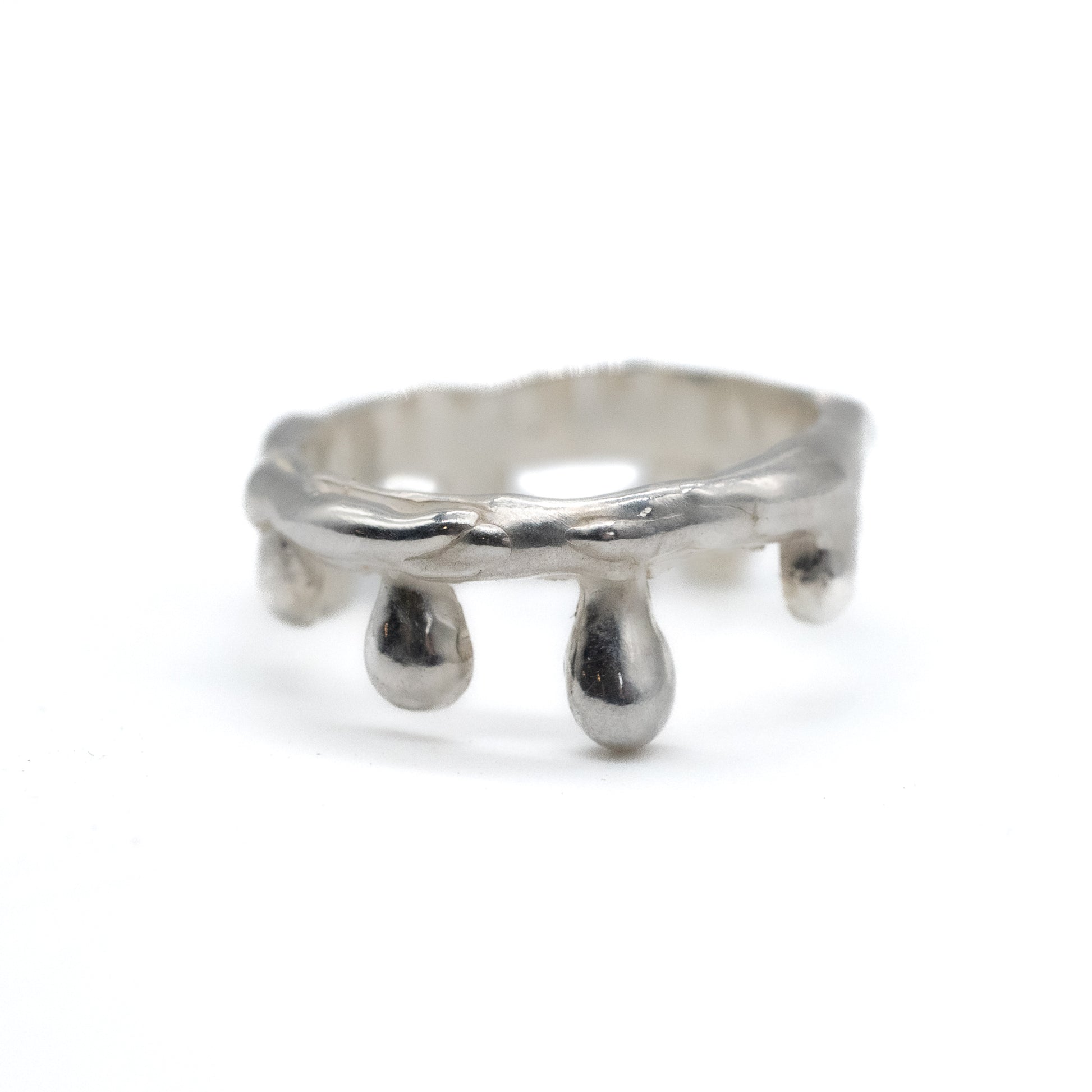 Silver ring with a unique design on a white background