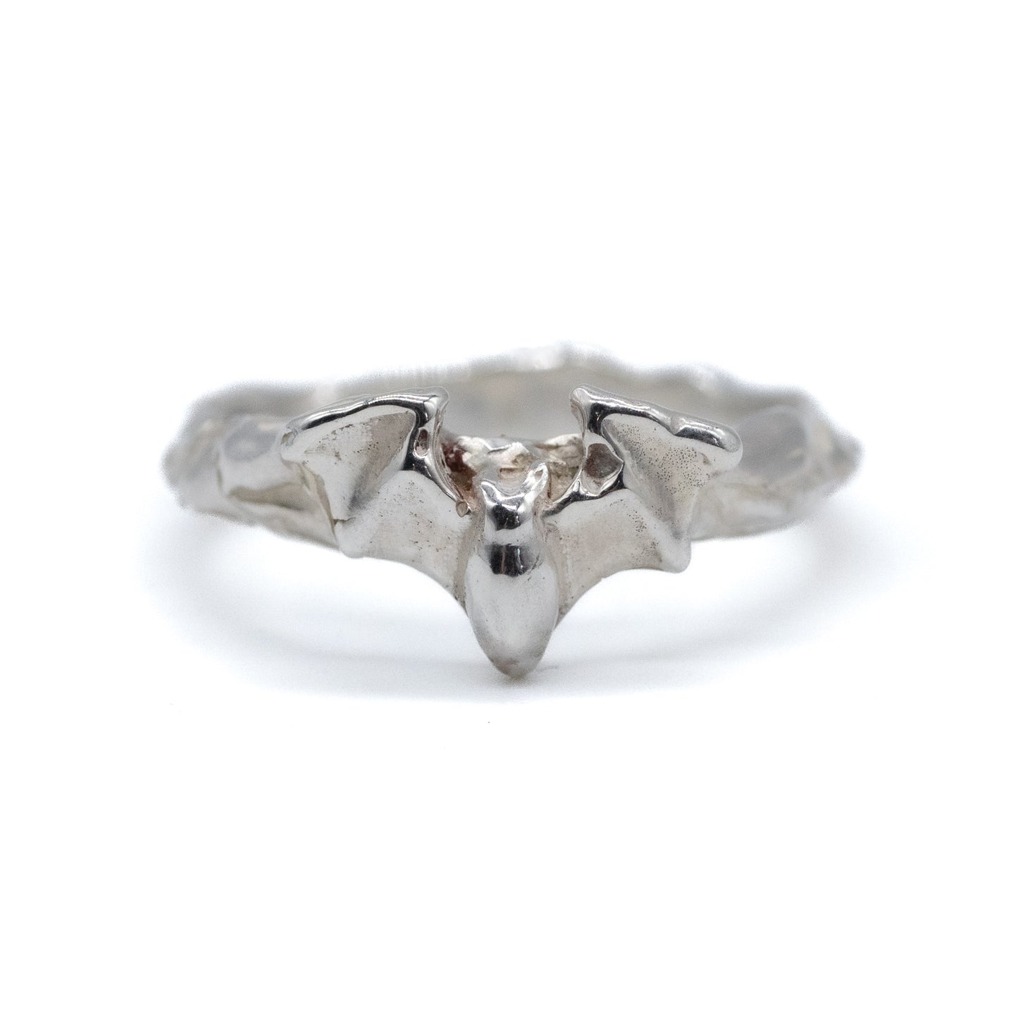 Silver bat-shaped ring on a white background