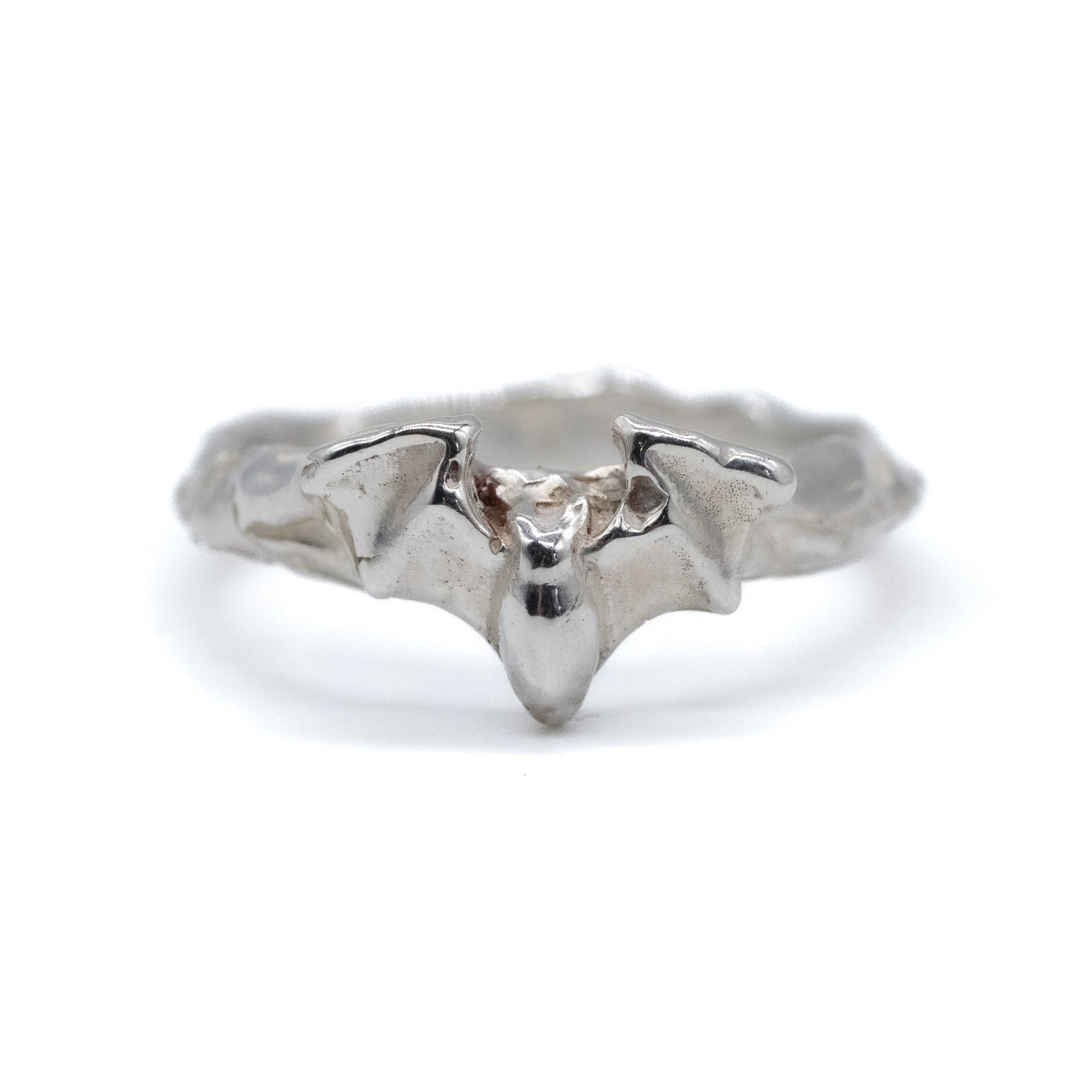 Silver bat-shaped ring on a white background