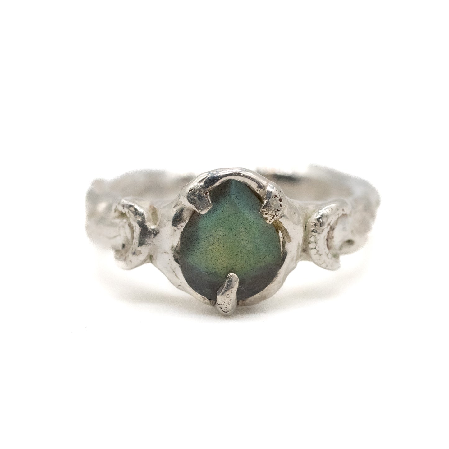 Silver moon ring with a green labradorite stone on a white background