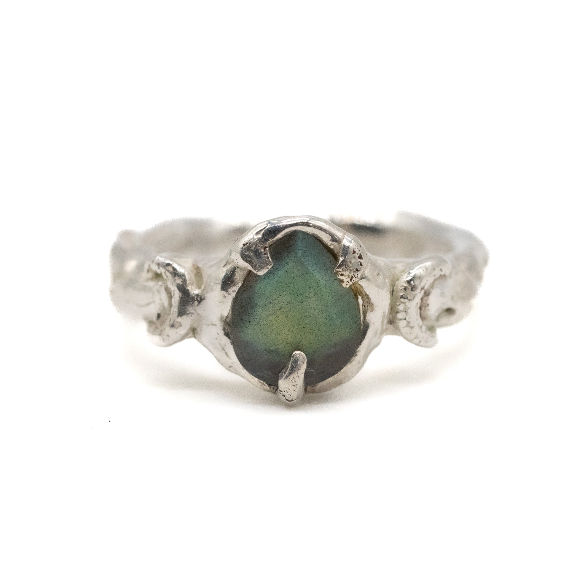 Silver moon ring with a green labradorite stone on a white background
