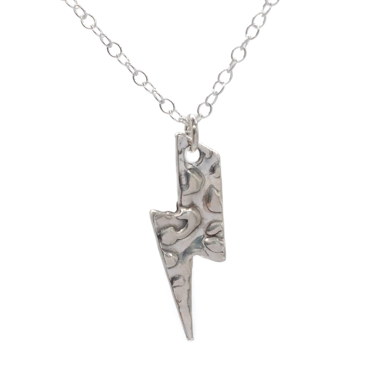 Silver lightning bolt pendant on a chain against a white background