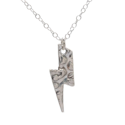 Silver lightning bolt pendant on a chain against a white background