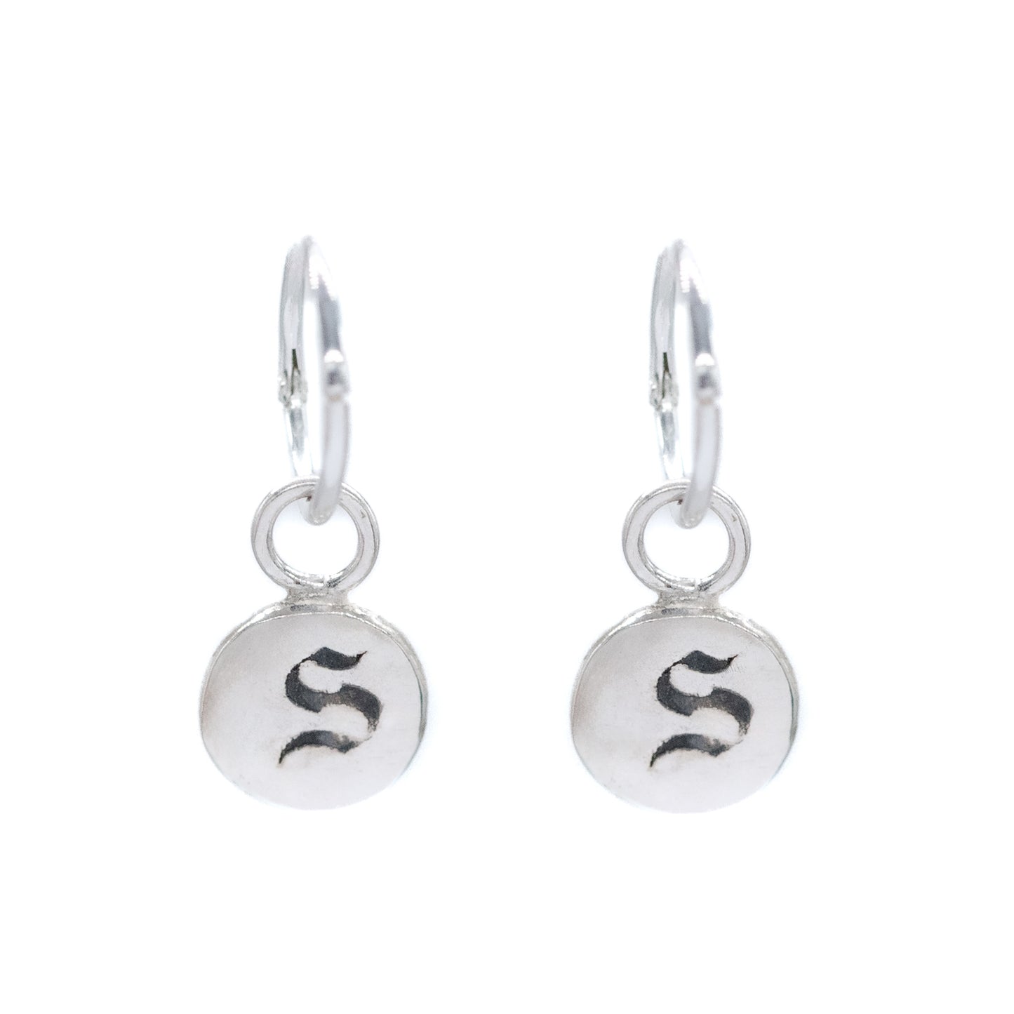 Pair of silver earrings with 'S' initials on a white background